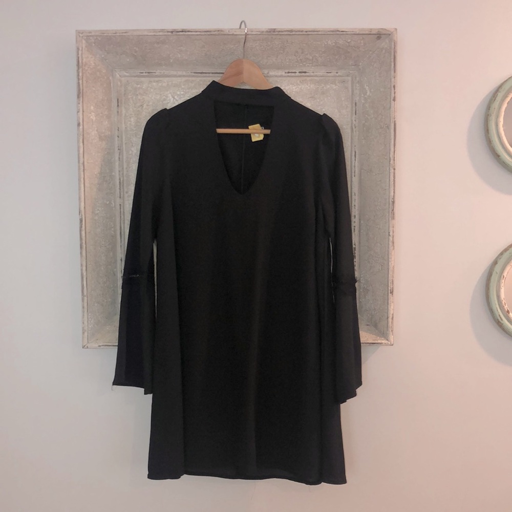 Black shift dress high neck with v neck cutout, bell sleeves with detailing.